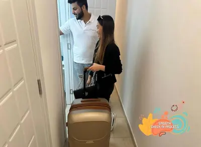 a man and a woman standing next to a suitcase at Familiar Partition Room In Tecom Near ICM Metro in Dubai
