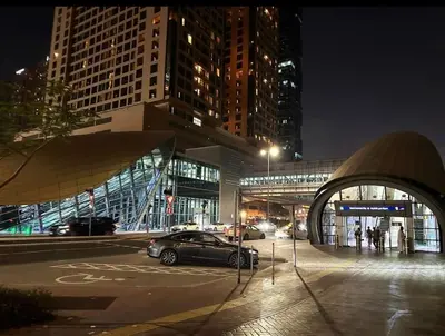 a car parked in a parking lot in a city at night at Familiar Partition Room In Tecom Near ICM Metro in Dubai
