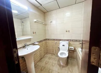 a bathroom with a toilet and a sink at Familiar Partition Room In Tecom Near ICM Metro in Dubai
