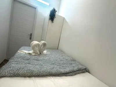 a white stuffed animal sitting on top of a bed at Rest Partition Room in Tecom Near Metro in Dubai