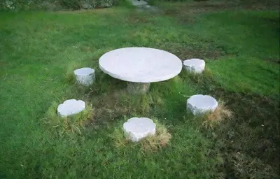 a white table in the middle of a field with rocks around it at Rest Partition Room in Tecom Near Metro in Dubai