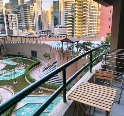 a balcony with a bench and a view of a city at Rest Partition Room in Tecom Near Metro in Dubai