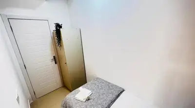 a white room with a chair and a door at Creative Partition Room in Barsha 1 Near Metro in Dubai