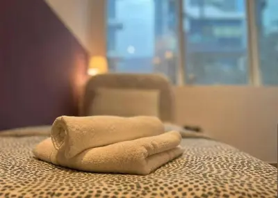 a towel sitting on top of a bed at Ideal Partition Room in Barsha 1 Near Metro in Dubai