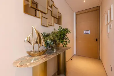 a hallway with a table with a boat on it at Elegant 2BR Apt Address Beach Resort in Dubai