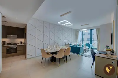 a dining room and kitchen with a table and chairs at Vogue Downtown Boulevard Heights near Dubai Mall and Burj Khalifa, Two Bedroom Apartment with balcony and Access to all Amenities in Dubai