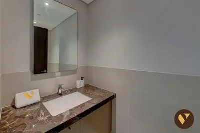 a bathroom with a sink and a mirror at Vogue Downtown Boulevard Heights near Dubai Mall and Burj Khalifa, Two Bedroom Apartment with balcony and Access to all Amenities in Dubai