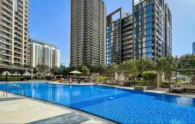 a large swimming pool in a city with tall buildings at Vogue Downtown Boulevard Heights near Dubai Mall and Burj Khalifa, Two Bedroom Apartment with balcony and Access to all Amenities in Dubai