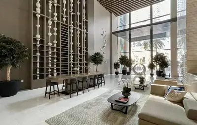 a living room with a couch and a table at Vogue Downtown Boulevard Heights near Dubai Mall and Burj Khalifa, Two Bedroom Apartment with balcony and Access to all Amenities in Dubai