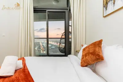 a bedroom with a white bed and a large window at Exclusive Sea-View 3Bhk 6pax in Dubai