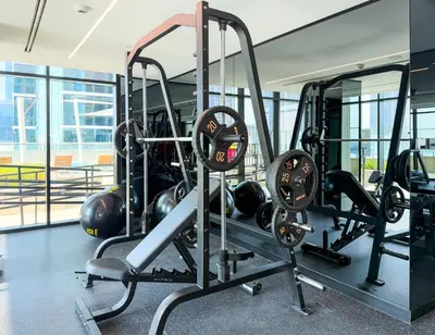 a gym with cardio equipment in a building at Sleek and Stylish 1BR Fully Furnished Apt in Dubai