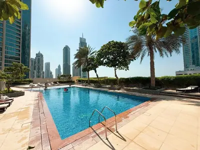 a swimming pool in a city with tall buildings at Beautiful 2 BR Apartment next to Opera I Burj View in Dubai