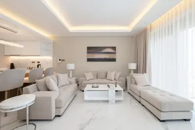 a living room with two couches and a table at Kempinski Central Avenue Residence 1BR- Direct access to Dubai Mall in Dubai