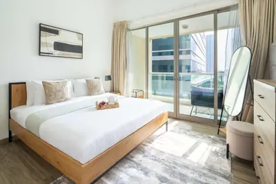 a bedroom with a large bed and a large window at Frank Porter - Marina Park in Dubai