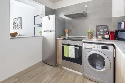 a kitchen with a washing machine and a refrigerator at Frank Porter - Marina Park in Dubai