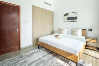 a bedroom with a large bed and a wooden door at Frank Porter - Marina Park in Dubai