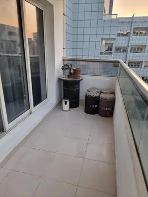 a balcony with two trash cans and two windows at The One by Anu in Dubai