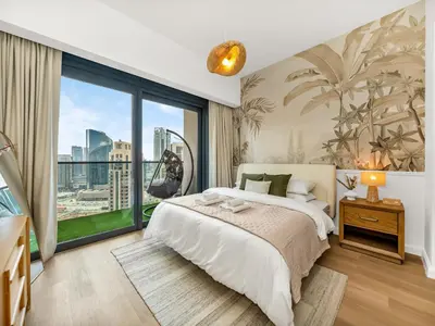 a bedroom with a bed and a large window at The Chic Downtown Suite Luxury near Burj Khalifa in Dubai