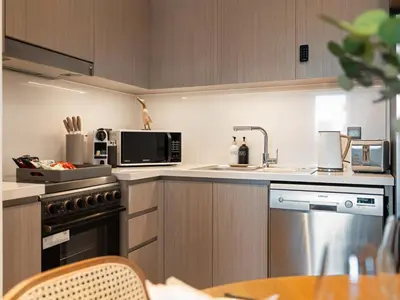 a kitchen with a sink and a microwave at The Chic Downtown Suite Luxury near Burj Khalifa in Dubai