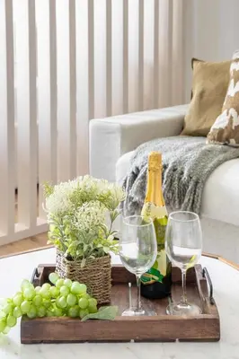 a tray with wine bottles and glasses on a table at Frank Porter - Rokane G25 in Dubai