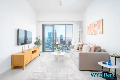 a living room with a couch and a large window at Sleek 1BR w Canal Views Next to Dubai Mall in Dubai