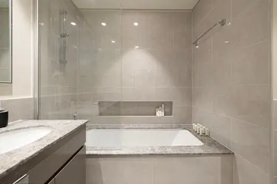 a large bathroom with a tub and a shower at LUXE - 2BR - Sea & City View - 5 Min to Dubai Mall in Dubai
