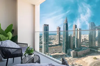 a balcony with a view of a city skyline at LUXE - 2BR - Sea & City View - 5 Min to Dubai Mall in Dubai