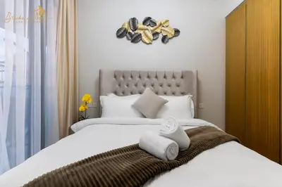 a bedroom with a large bed with towels on it at Glorious Sea View 3Bhk 6pax in Dubai