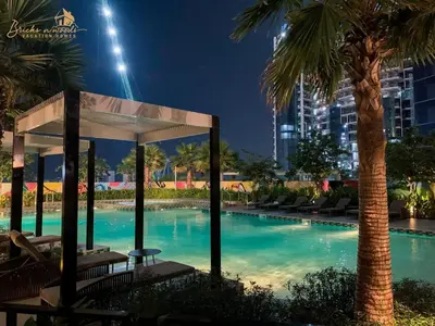 a swimming pool at night with a gazebo and palm trees at Glorious Sea View 3Bhk 6pax in Dubai