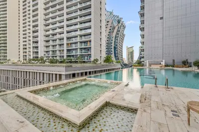 a swimming pool in a city with tall buildings at LUX Apt 5 min away from Burj Khalifa & Dubai Mall in Dubai