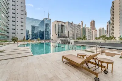 a pool on the roof of a building with buildings at LUX Apt 5 min away from Burj Khalifa & Dubai Mall in Dubai