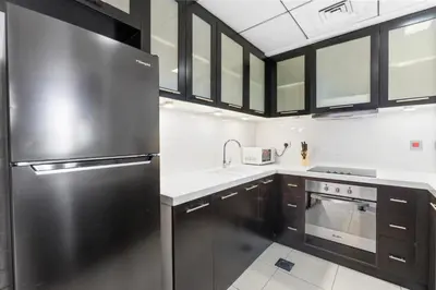 a kitchen with a stainless steel refrigerator and a sink at Stunning 1 BR in JBR Dubai Marina The Walk in Dubai