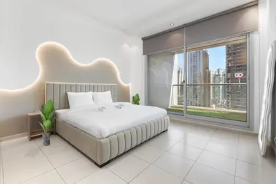 a bedroom with a large bed and a large window at Stunning 1 BR in JBR Dubai Marina The Walk in Dubai