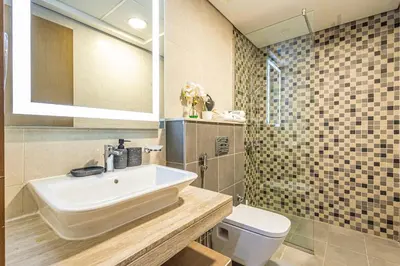 a bathroom with a sink and a toilet at Modern 2BR Glowing Palm Trees Near Downtown in Dubai