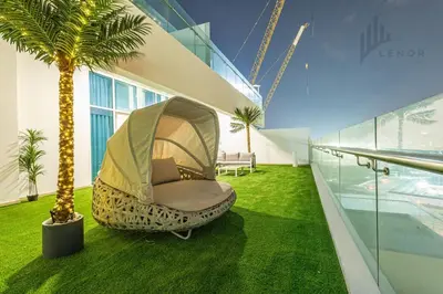 a room with a hammock and a palm tree at Modern 2BR Glowing Palm Trees Near Downtown in Dubai