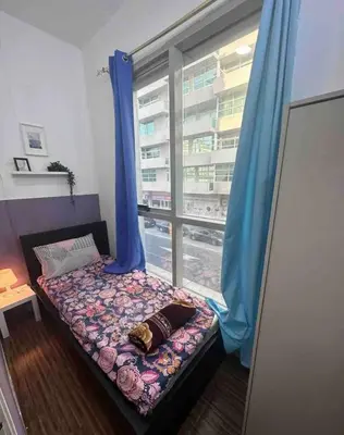 a bed in a room with a window at Partition Room with window Near Mashreq Metro in Dubai