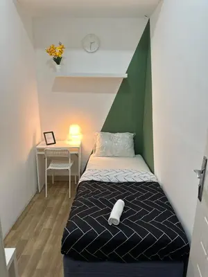a small room with a bed and a desk at Cityscape Room In Tecom Near ICM Metro in Dubai
