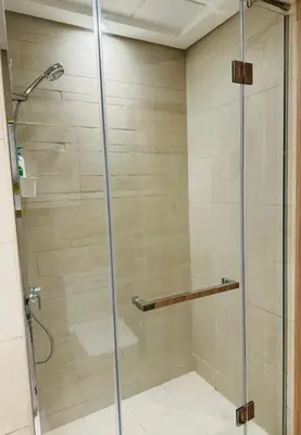 a shower with a glass door in a bathroom at Azizi Rivera Luxury Studio in Dubai