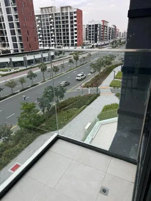 a view of a city street from a window at Azizi Rivera Luxury Studio in Dubai