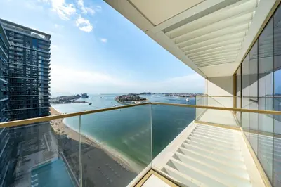 a view of the ocean from the balcony of a building at Homes Beyond I Stylish 2BR Beachfront Bliss in Dubai