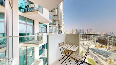 two chairs on the balcony of a building at Stylish Studio Retreat in Azizi Farhad in Dubai