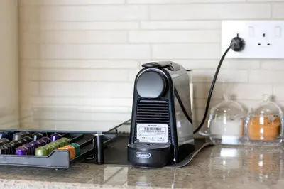 a phone sitting on a counter next to a toaster at Elegant 4BR Apartment with Burj Khalifa and Fountain Views Connected to Dubai Mall in Dubai