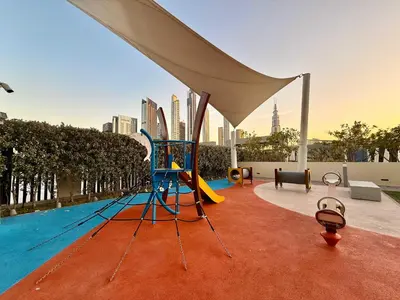 a swimming pool with a playground next to a pool at Elegant 4BR Apartment with Burj Khalifa and Fountain Views Connected to Dubai Mall in Dubai