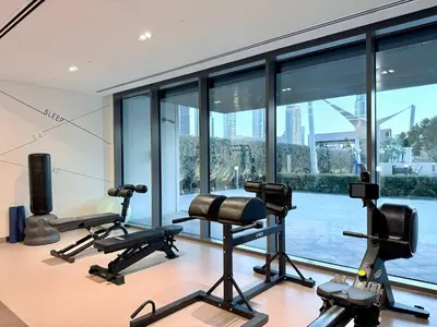 a gym with exercise equipment and a large window at Elegant 4BR Apartment with Burj Khalifa and Fountain Views Connected to Dubai Mall in Dubai