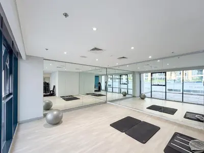 a large room with yoga mats and mirrors at Chic & Beautiful Home in the Heart of Meydan in Dubai