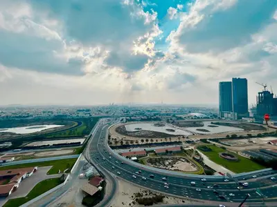 an aerial view of a city with traffic on a highway at Homes 2 Retreat - Luxury & Spacious 1BR with Balcony in Business Bay in Dubai