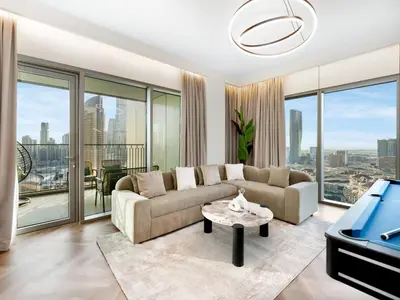 a living room with a couch and a table at Royal Vista - Luxury 4BR Apartment at Downtown Views II - Downtown in Dubai