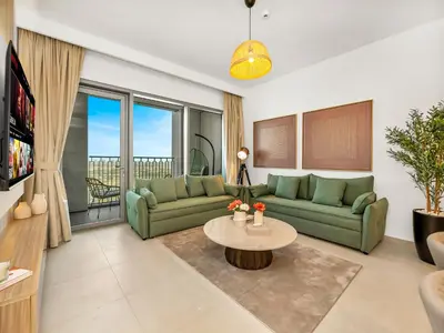 a living room with a couch and a table at Royal Vista - Luxury 4BR Apartment at Downtown Views II - Downtown in Dubai