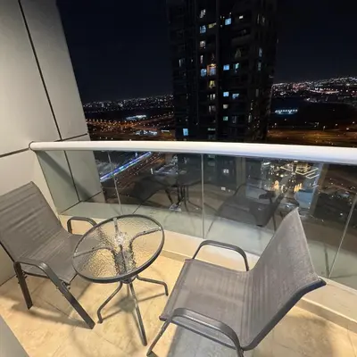 a balcony with a table and chairs on a building at Preatoni Tower - JLT by Golden Casa in Dubai