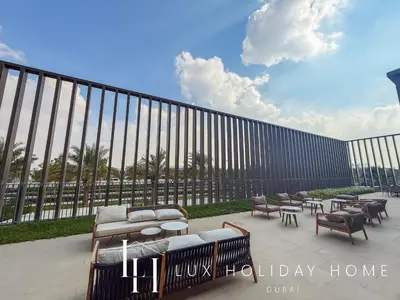 a row of benches and tables in front of a fence at LUX The Collective Dubai Hills Suite in Dubai